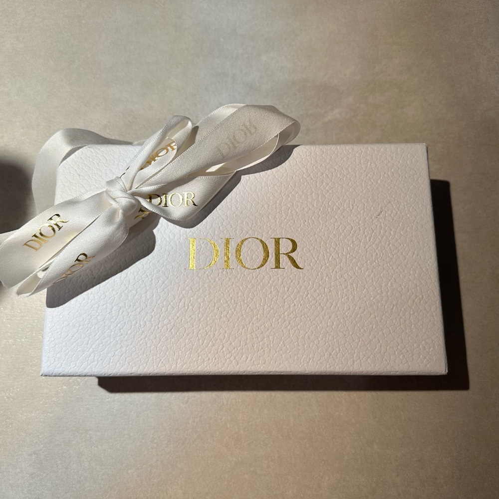 Dior white box with tissues, dust bag, and gold ribbon